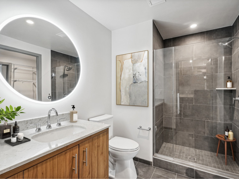Spacious vanities with hotel-style, backlit mirrors in bathrooms